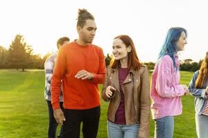 Group of friends walking and talking in the park photo