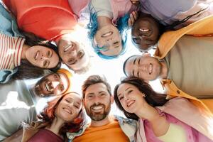Diverse group of people forming circle smiling together photo