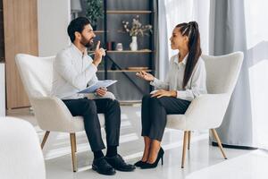 Portrait of happy, smiling professional doctor, psychologist talking with attractive woman photo