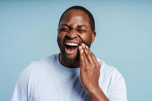 African American man feeling strong toothache posing in studio photo