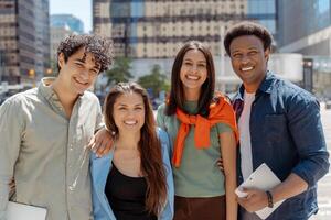 Group of young professionals smiling outdoors in the city photo