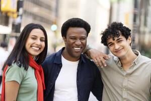Group of friends is smiling in a big city street photo