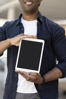 Man smiling and showing digital tablet with empty screen photo