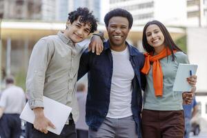 Three students smiling and walking together on campus photo