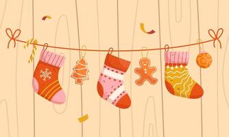 Christmas socks on a string on a wooden background vector
