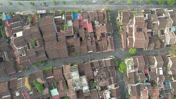 Aerial view of traditional tiled rooftops in a densely packed urban neighborhood, symbolizing heritage and community video