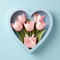 A heart shaped display holds pink flowers and a gift on a soft blue background photo