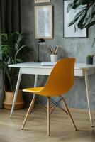 Bright yellow chair beside a modern desk in a stylish home office with plants and decor photo