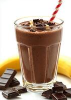 Decadent chocolate banana smoothie topped with chocolate pieces and a striped straw photo