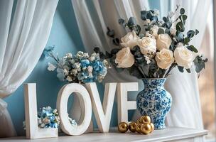 Bright setup with blue flowers, white love letters, and golden treats photo