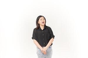beautiful Asian woman turns to the side, looking intently and shouting, with a dramatic expression against a white background photo