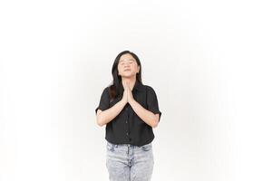 beautiful Asian woman in a praying pose, hands together and eyes closed, expressing hope against a white background photo