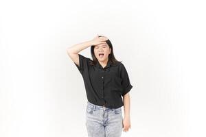 beautiful Asian woman holds her head in pain, with a pained expression showing signs of a headache against a white background photo