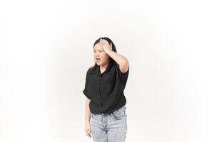 beautiful Asian woman holds her head in pain, with a pained expression showing signs of a headache against a white background photo