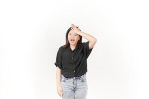 beautiful Asian woman holds her head in pain, with a pained expression showing signs of a headache against a white background photo