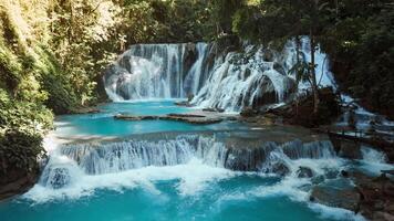 Cascade waterfalls with turquoise water in Central Sulawesi, scenic drone view video