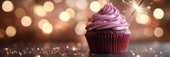 Delicious chocolate cupcake topped with pink frosting and sparkling candle on a festive background photo