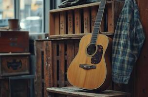A rustic acoustic guitar rests against a wooden crate in a cozy indoor setting photo