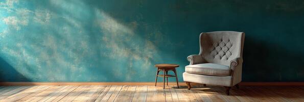 Cozy corner with a vintage armchair and small wooden table against a textured blue wall photo