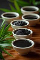 Various natural ingredients arranged in bowls on a bamboo mat for culinary purposes photo