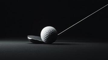 A detailed view of a golf ball resting on a tee against a dark backdrop photo