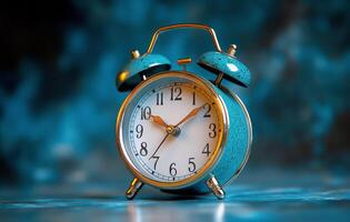 Classic blue alarm clock on a blue background showcasing timeless design and functionality photo