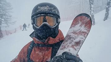 Snowboarder in winter gear enjoys a snowy day on the mountain with fresh powder falling photo