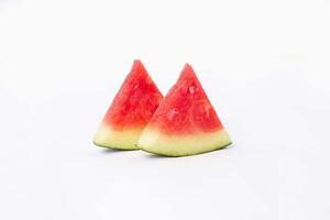 Whole watermelon and seeded slices seen front and top on a white background. Watermelon slices are red, seedy and juicy. photo