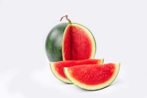 Whole watermelon and seeded slices seen front and top on a white background. Watermelon slices are red, seedy and juicy. photo