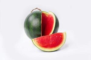 Whole watermelon and seeded slices seen front and top on a white background. Watermelon slices are red, seedy and juicy. photo