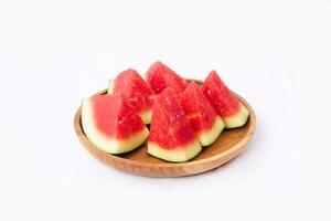 Whole watermelon and seeded slices seen front and top on a white background. Watermelon slices are red, seedy and juicy. photo