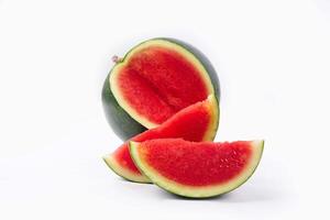 Whole watermelon and seeded slices seen front and top on a white background. Watermelon slices are red, seedy and juicy. photo