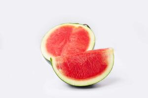 Whole watermelon and seeded slices seen front and top on a white background. Watermelon slices are red, seedy and juicy. photo