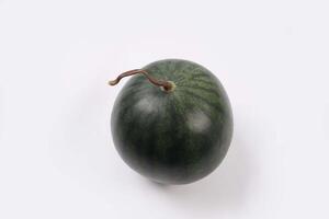 Whole watermelon and seeded slices seen front and top on a white background. Watermelon slices are red, seedy and juicy. photo