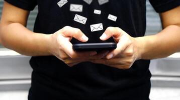 Businessman sending large amount of SMS messages on smartphone, show message box virtual. Bulk messaging, communication online, software technology and the virtual assistant on communication internet. photo
