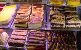 Delectable assortment of pastries displayed in a vibrant bakery case during a busy afternoon photo