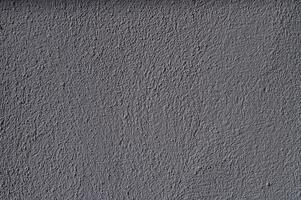 Textured gray wall showcasing subtle variations in color and shadow during the late afternoon light photo