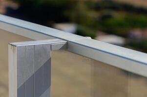 A Bright Sunny Day Reveals Modern Architectural Details of a Balcony Railing Overlooking a Serene Landscape Filled With Greenery photo