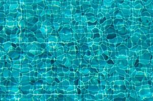Dazzling Azure Surface of a Tranquil Pool Reflecting Sunlight on a Warm Summer Afternoon photo