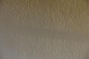Textured Wall With a Soft Gradient Showcasing Unique Patterns and Light Reflections in a Quiet Indoor Setting During the Afternoon photo