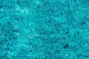Captivating Turquoise Water Reflecting Sunlight Creates a Serene Atmosphere at a Tranquil Pool on a Sunny Afternoon photo