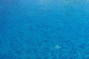 Luminous Turquoise Waters Inviting Refreshment Under the Radiant Summer Sun in a Tranquil Resort Setting photo