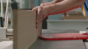 Industrial background with details of the workshop of the woodworking factory. Creative. Carpentry worker with a wooden board. video