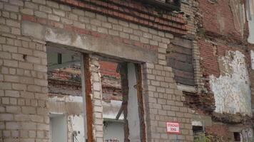 Old abandoned house with collapsed walls. Clip. Abandoned residential building with no windows. Ruins of old residential building with bricks video
