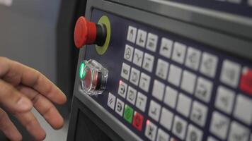 Close up of worker hand touching small control panel with many buttons. Media. Computer and machinery at the factory, hand pressing red button, concept of nuclear war. video