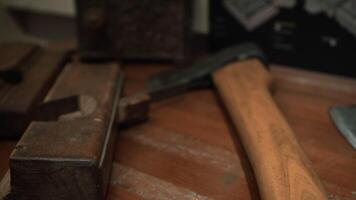 Weapons lying on the table. Media. Axes with sharpened noses that lie next to the equipment video