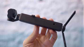 Accessory for shooting. Action. A small camera that is attached to a special tripod and taken in close-up. video