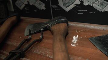 Weapons lying on the table. Media. Axes with sharpened noses that lie next to the equipment video