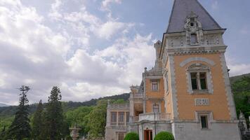 Beautiful view of ancient architecture of palace. Action. Beautiful architecture of palace in European style on background of green forest. European Palace in green mountains in summer video
