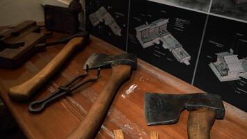 Analysis of items for repair. Media. Huge axes and iron keys that lie on the table next to the wall charts. video